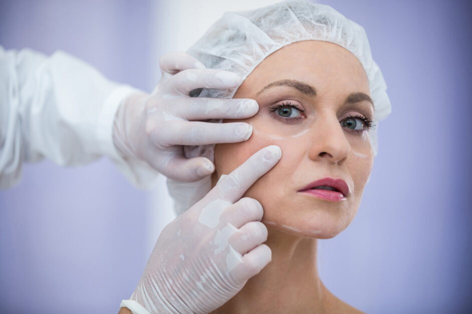 a woman in a hair cap and gloves touching her face